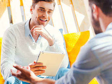Two people looking at an app on a tablet